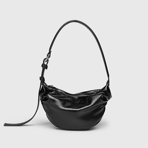 Black crinkled patent leather crescent shoulder bag with minimalist hobo styling