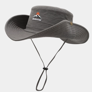Detail of dark grey outdoor hat with mountain embroidery and adjustable chin strap