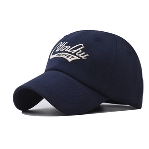 Detailed close-up of white 3D letter embroidery on navy blue cotton baseball cap