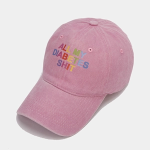 Detail of pink washed cotton baseball cap with All My Diabetes Shit text printing