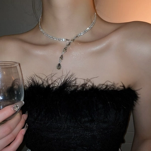 Close-up of double-layer silver choker with sparkling teardrop crystal pendants