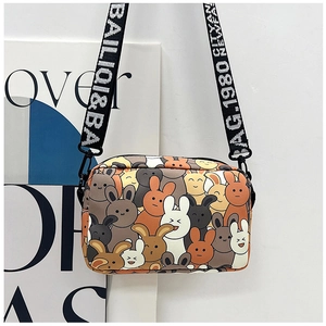 Detail view of cartoon rabbit print small crossbody bag with wide letter-patterned strap
