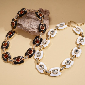 Vintage gold adjustable sweater necklace with enamel oval pendant and inlaid rhinestones