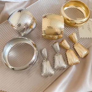 Chic gold and silver plated jewelry set with textured bracelets and woven geometric earrings