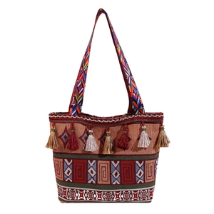 Ethnic style woven tote bag featuring geometric embroidery and colorful tassel charms