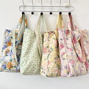 Detailed collection of four floral canvas tote bags with various prints and side logo labels