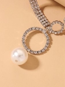 Macro shot of luxury silver choker with a large pearl and sparkling rhinestone rings