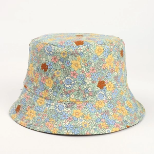 Close-up of lightweight bucket hat with colorful daisy floral print on high-quality fabric