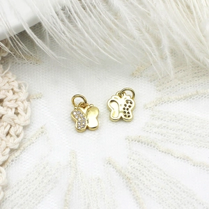 Macro view of gold butterfly charms with cubic zirconia stones for DIY jewelry making