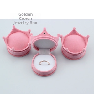 Pink crown shaped velvet jewelry box detail showing ring slot and soft flocked texture