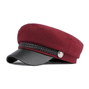 Vintage burgundy wool baker boy hat with black faux leather brim and metallic button detail