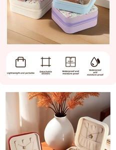 Detailed view of portable jewelry box features with hooks, ring slots and removable dividers