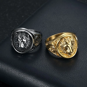 Hip-hop gold and silver lion head rings for men on black textured background