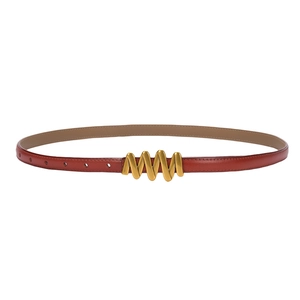 Elegant red leather skinny belt for women with a unique gold wavy buckle on white background