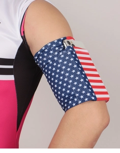 Detail view of elastic sports arm band with USA flag pattern holding a smartphone