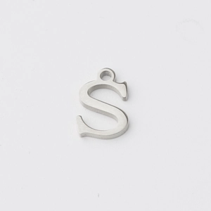 Macro shot of silver stainless steel letter S pendant charm with mirror finish for DIY jewelry