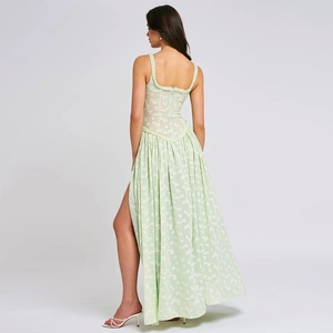Macro shot of the back zipper detail and side slit on the pale green textured maxi dress
