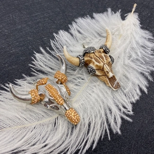 Bull head pendants in silver and bone finish with crystal inlay on white feathers