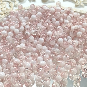 Macro shot of 10mm pink and white gradient crackle glass beads for DIY jewelry making