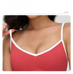 Detail view of the V-neckline and white contrast trim on a red sports bra for women
