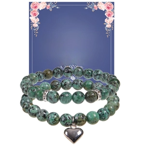 Detail of pink zebra stone bracelets with heart pendant and motivational message card