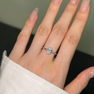 Close-up of S925 silver ring featuring an oval-cut ice flower sparkling stone on a hand