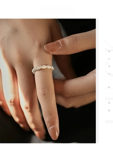 Detail of S925 sterling silver multi-layered wire ring with elegant white pearls