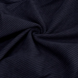 Macro shot of navy blue corduroy fabric showing detailed ribbed texture and soft drape