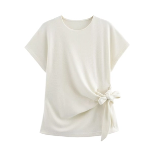 Detail of white knit short sleeve top featuring side tie-up bow design and round neckline