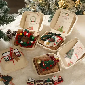 Handmade felt Christmas tree pendants in a gift box with festive cards and snow decor