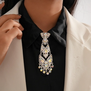 Detail of silver geometric rhinestone tie necklace with tassels on black shirt