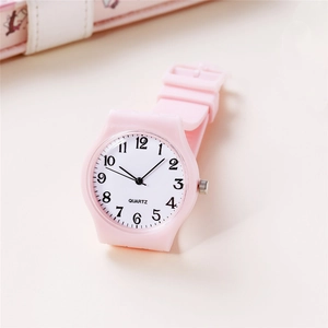 Detailed macro view of pink silicone watch with clear black numerals and white dial
