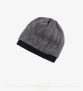 Close-up of thick gray plush lining and black ribbed knit edge on warm winter beanie
