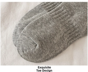Macro shot of grey ribbed knit socks with seamless toe stitching and soft cotton texture