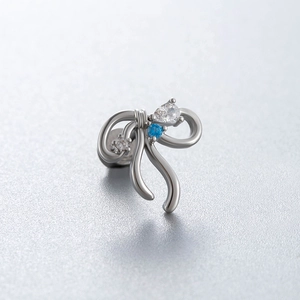 Bow-shaped silver titanium steel cartilage stud earring with blue and clear gemstones