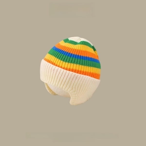 Close-up of rainbow striped knit baby hat with ear flaps and thick cotton lining