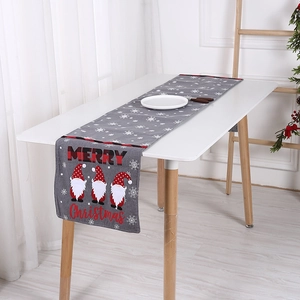 Grey knitted Christmas table runner with Merry Christmas text and festive gnome design