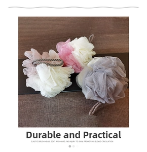 Detail view of large soft bath loofahs in pink and beige with durable hanging cords