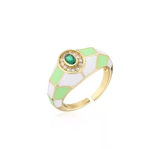 Detail of 18K gold ring featuring green oval gemstone and colorful enamel patterns