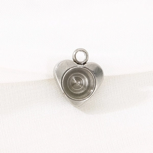 Close-up of heart-shaped stainless steel pendant base with inlay groove for DIY jewelry