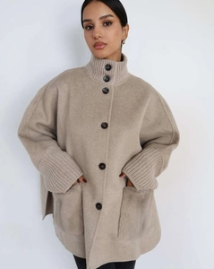 Detail of oatmeal wool coat with knitted collar and fuzzy mink texture pockets