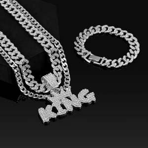 Nahaufnahme von Hip-Hop-Schmuckset mit KING-Anhänger und silberner Panzerkette mit Strass