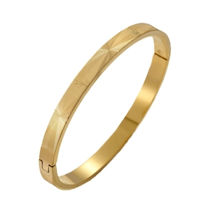 Titanium steel gold bangle with engraved radial crown patterns on white background
