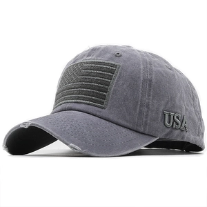 Detail of 3D USA embroidery and distressed ripped brim on a grey baseball cap