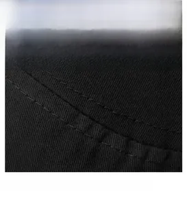 Detailed macro view of the parallel double-stitch sewing on the black cotton flat top hat