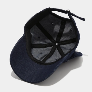 Detailed interior of vintage washed denim baseball cap with adjustable metal strap buckle