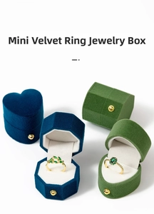 Detailed view of mini velvet ring boxes in heart and octagon shapes with gold clasp