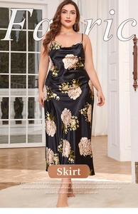 Detail of plus size black satin slip dress with white floral print and cowl neck