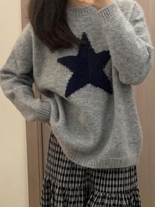 Minimalist grey round neck sweater featuring a large dark blue star pattern on front