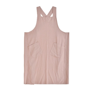 Japanese style pink linen cross back apron with dual front pockets on white background